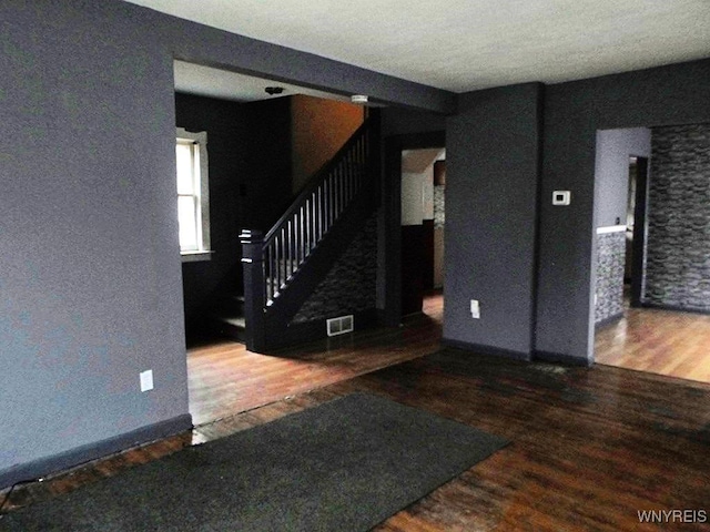 unfurnished living room featuring dark wood-type flooring