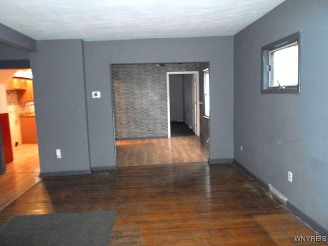 empty room featuring dark wood-type flooring