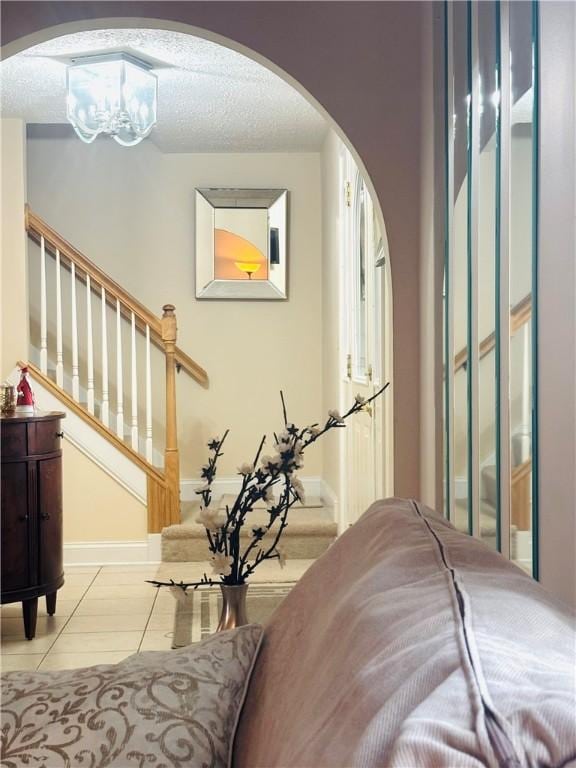 interior space featuring a textured ceiling and a notable chandelier