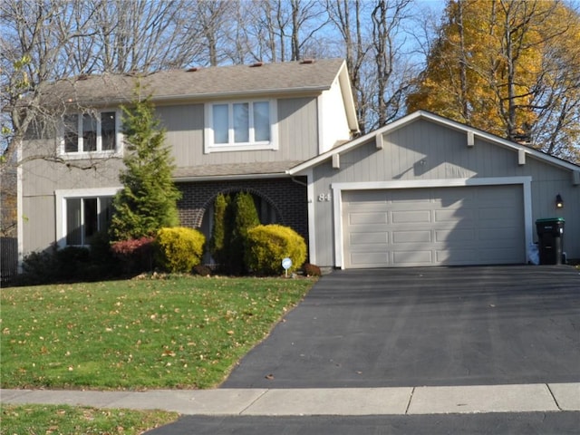 view of front facade featuring a front lawn and a garage