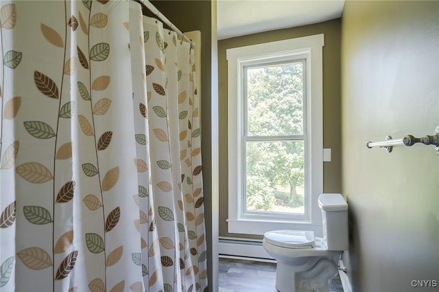 bathroom with hardwood / wood-style floors, curtained shower, toilet, and baseboard heating