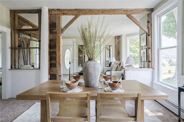 carpeted dining room featuring baseboard heating and a wealth of natural light