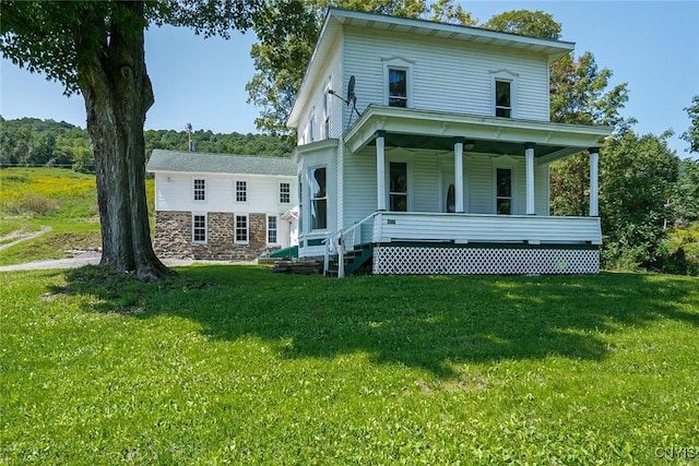 view of front facade featuring a front lawn and covered porch