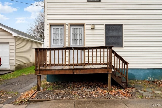 view of exterior entry featuring a wooden deck