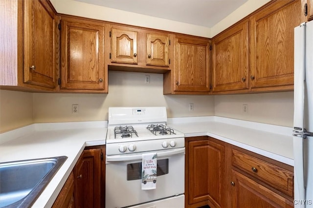 kitchen featuring sink and white appliances