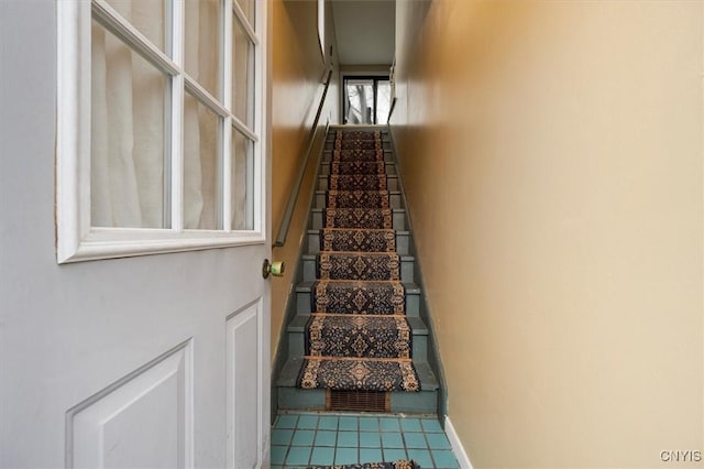 staircase with tile patterned floors