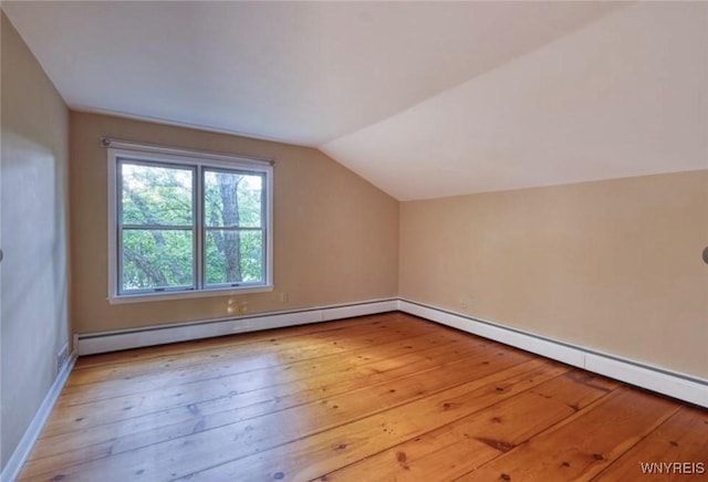 bonus room featuring baseboard heating, vaulted ceiling, and light hardwood / wood-style flooring