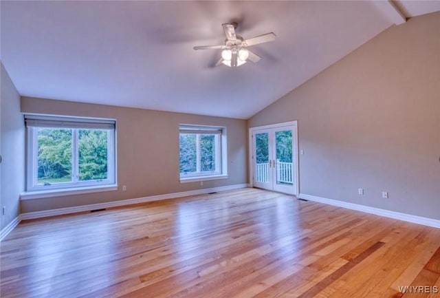 spare room with ceiling fan, light hardwood / wood-style floors, and vaulted ceiling