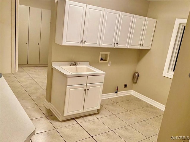 laundry room with sink, cabinets, light tile patterned floors, hookup for a washing machine, and electric dryer hookup