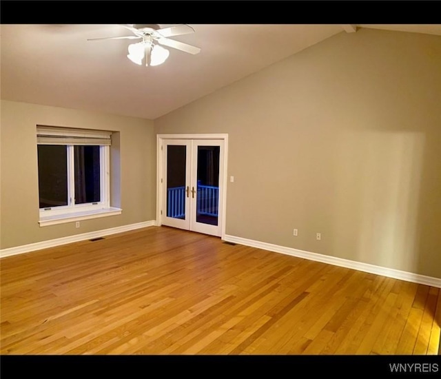 unfurnished room featuring vaulted ceiling, light hardwood / wood-style flooring, ceiling fan, and french doors