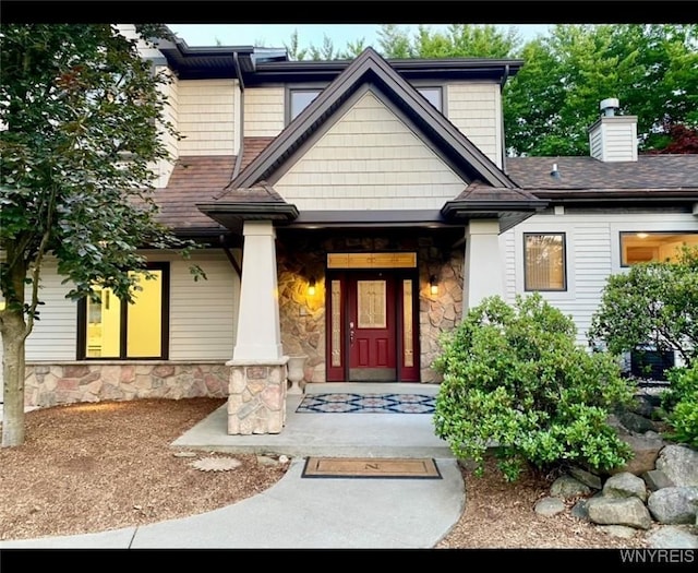 view of exterior entry with covered porch