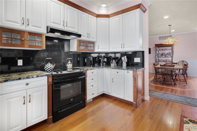 kitchen with backsplash, black / electric stove, white cabinets, and pendant lighting