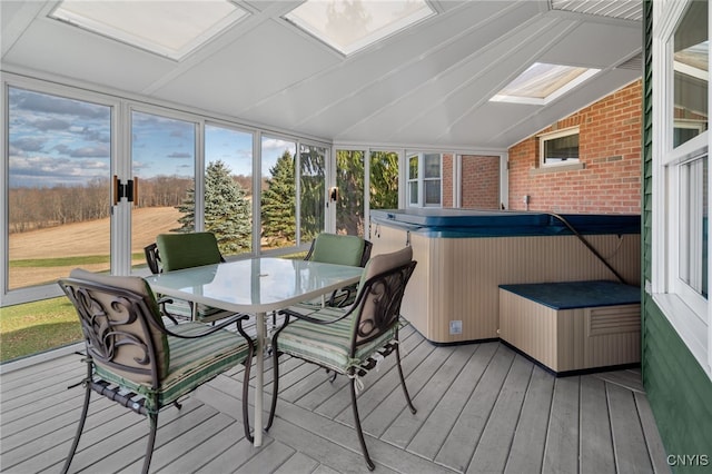 sunroom with vaulted ceiling with skylight