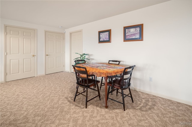 dining space with light colored carpet