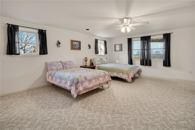 bedroom with ceiling fan and carpet floors