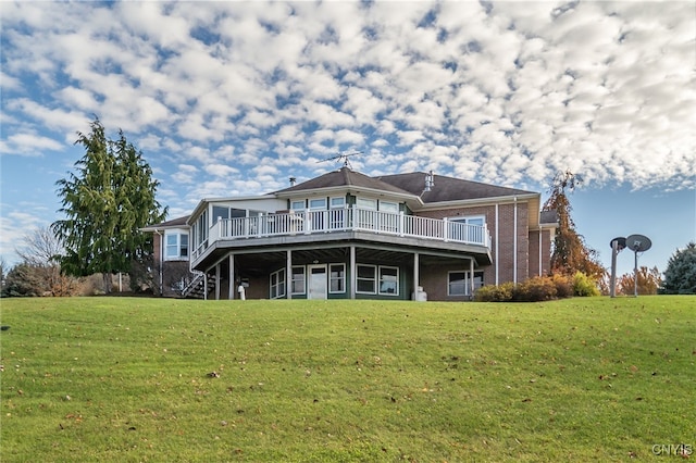 rear view of house featuring a lawn and a deck