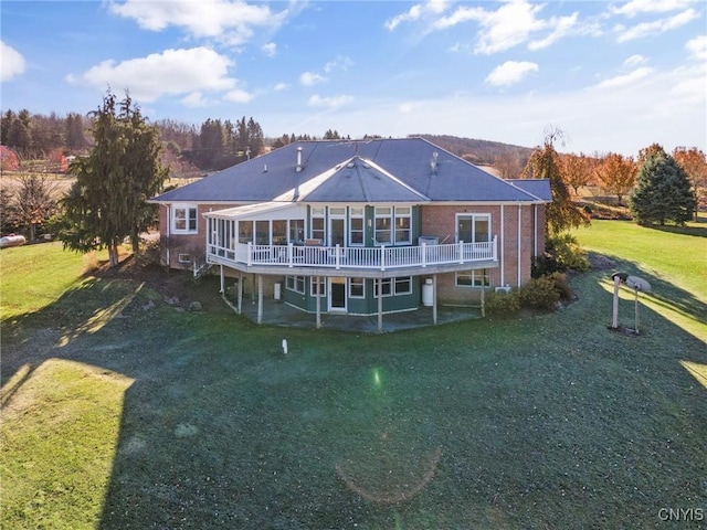 back of house featuring a yard and a wooden deck