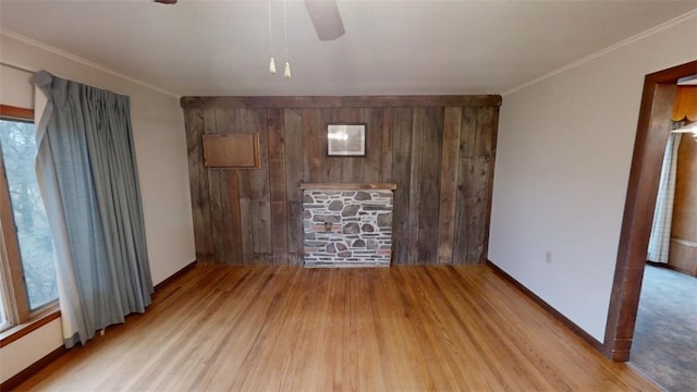 unfurnished living room with light hardwood / wood-style flooring, ceiling fan, and ornamental molding