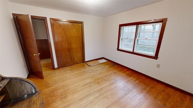 unfurnished bedroom featuring light hardwood / wood-style floors and ornamental molding