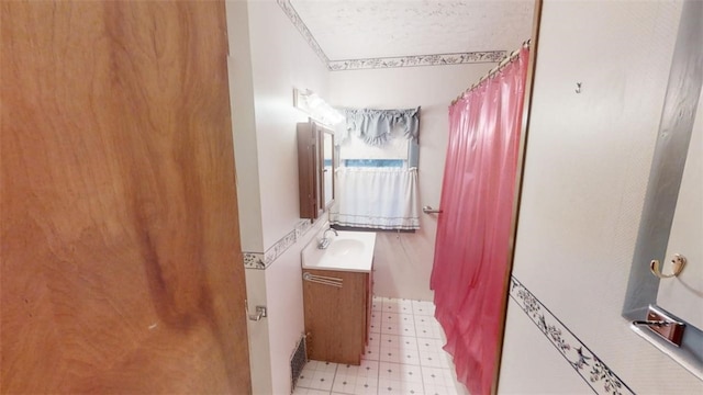 bathroom with vanity and ornamental molding