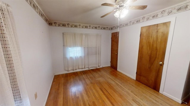 unfurnished bedroom featuring ceiling fan, light hardwood / wood-style floors, and crown molding