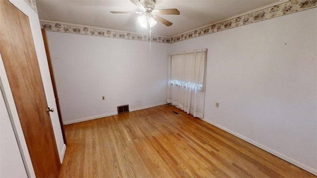 empty room with ceiling fan and light hardwood / wood-style floors