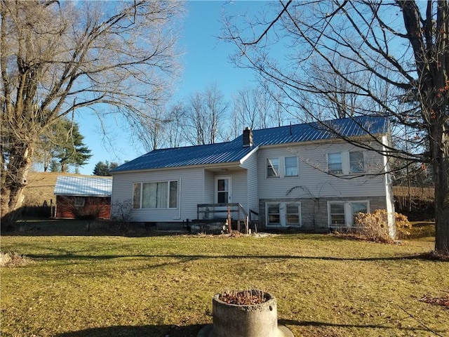 rear view of property featuring a yard