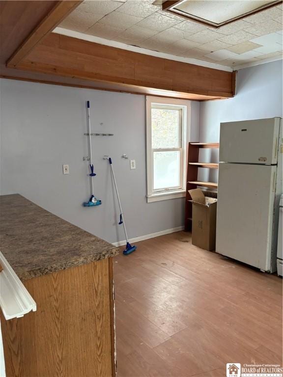 kitchen with white fridge and light hardwood / wood-style flooring