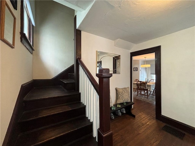 staircase with hardwood / wood-style flooring