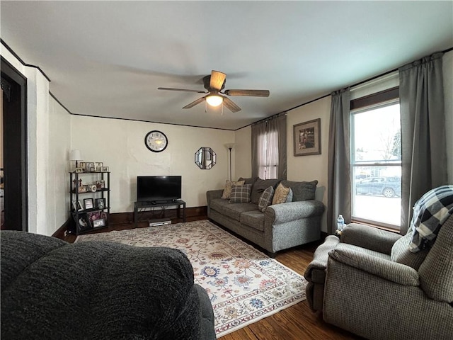 living room with ceiling fan and dark wood-type flooring