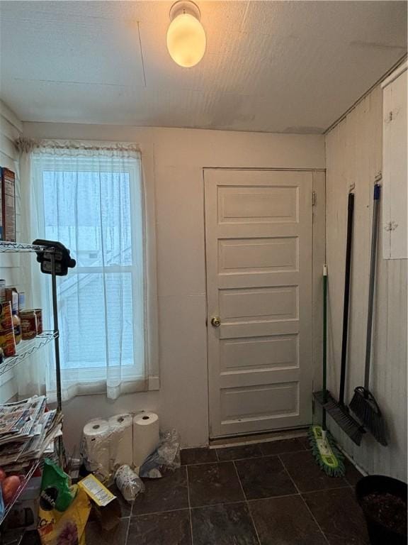 doorway featuring dark tile patterned floors