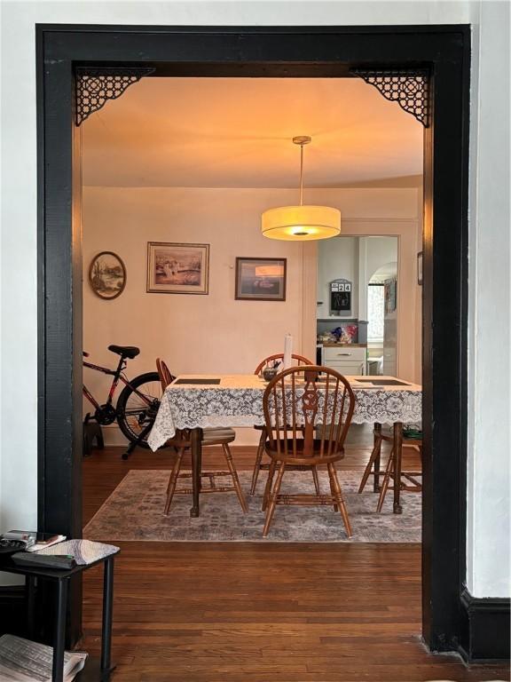 dining area featuring dark wood-type flooring