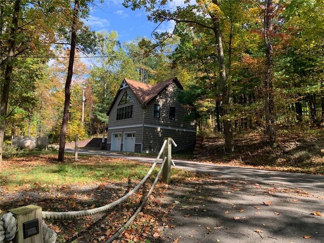 4555 Davies Rd, Hector, NY 14818 - view of home's exterior with an attached garage and asphalt driveway