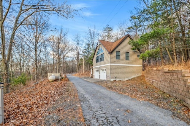4555 Davies Rd, Hector, NY 14818 - view of home's exterior with an attached garage and driveway