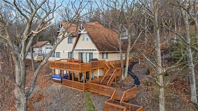 rear view of house featuring a wooden deck