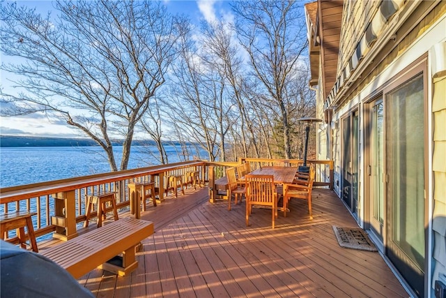 wooden terrace featuring a water view