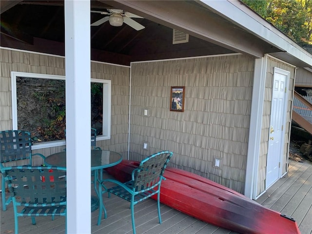 wooden terrace featuring ceiling fan