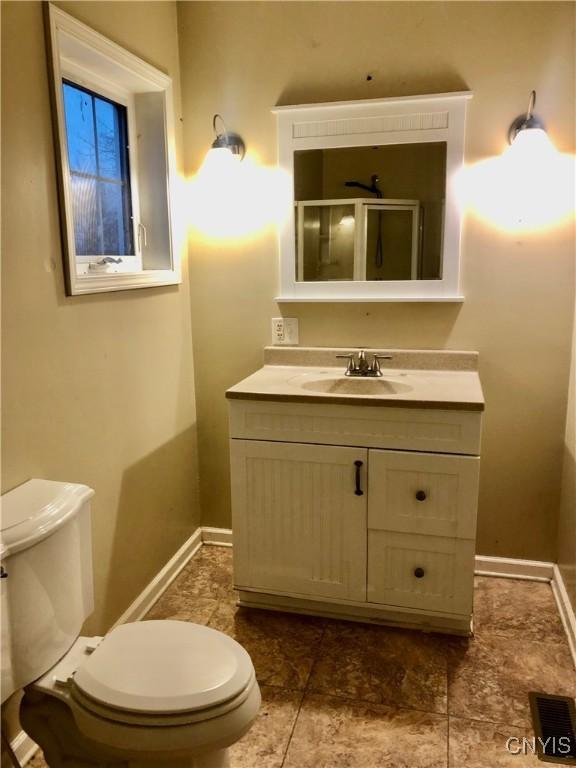 bathroom featuring vanity and toilet