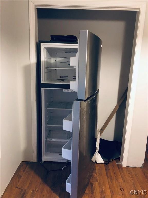 room details with stainless steel refrigerator and dark wood-type flooring