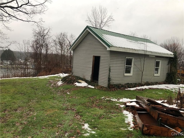 view of outbuilding with a lawn