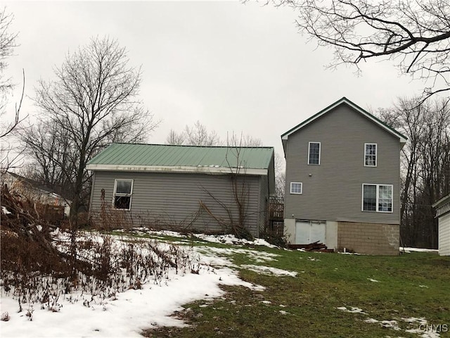 snow covered property with a lawn