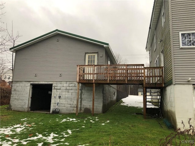 rear view of house featuring a lawn and a wooden deck