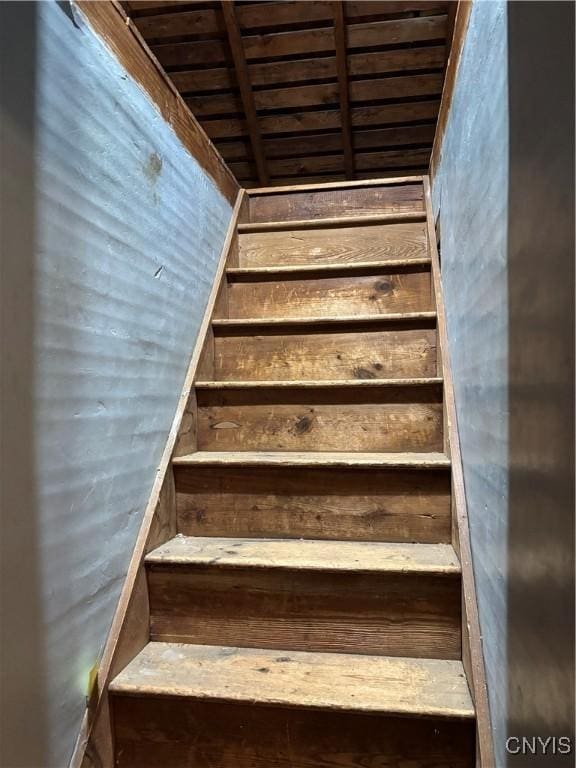 staircase with wooden ceiling