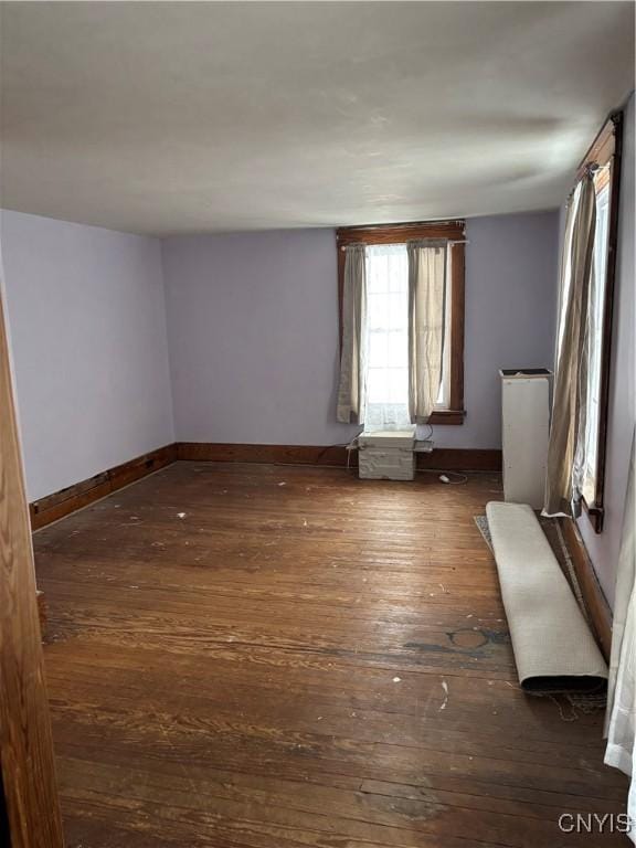 spare room with dark wood-type flooring