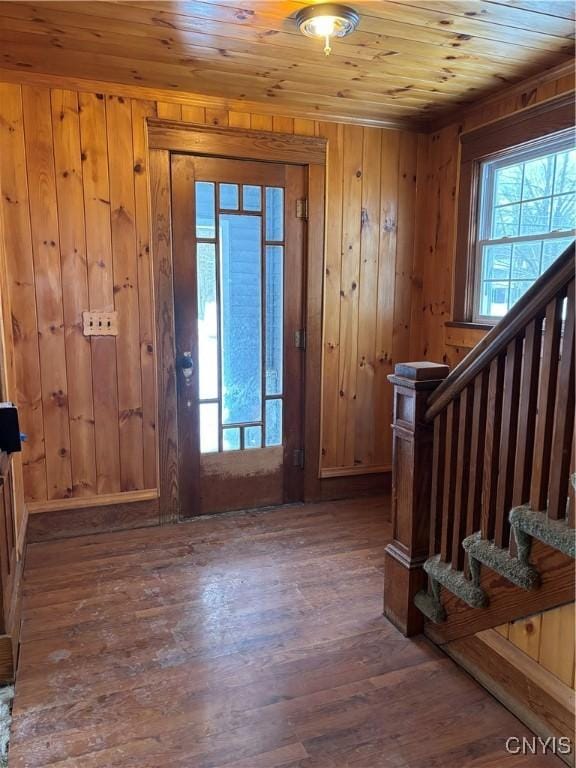 entrance foyer featuring wood walls, dark hardwood / wood-style flooring, and wood ceiling