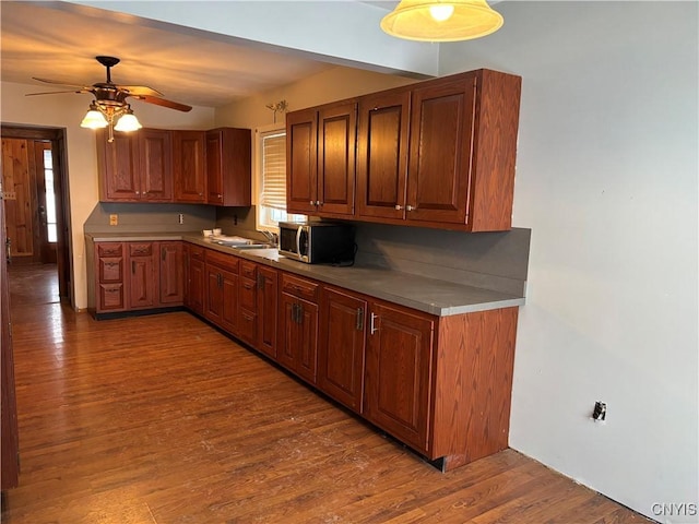 kitchen featuring hardwood / wood-style floors, ceiling fan, and sink