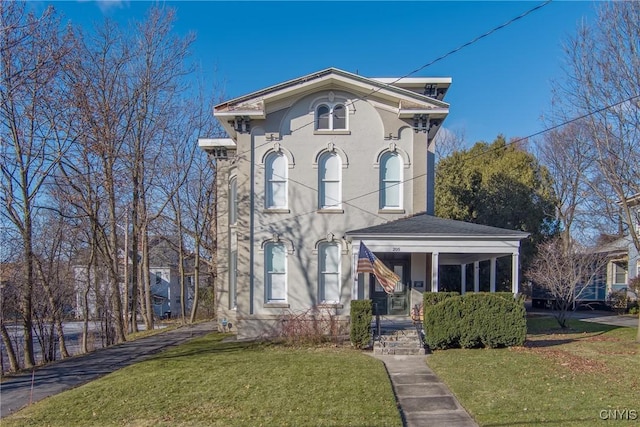 italianate home with a front lawn and a porch