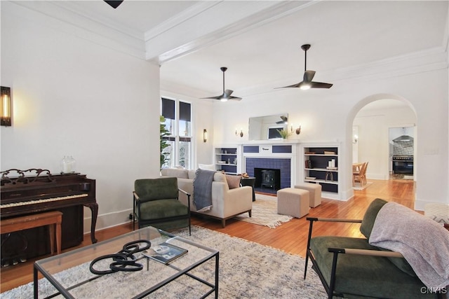 living room with ceiling fan, light hardwood / wood-style flooring, and ornamental molding