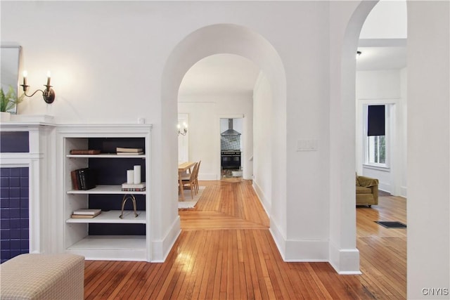 hallway with hardwood / wood-style floors