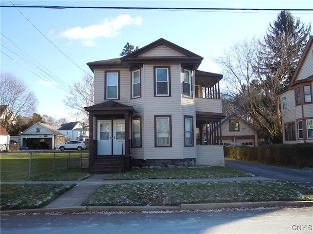 view of front of home featuring a balcony and a front lawn